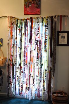 an image of a curtain made out of different colored ribbons and beads hanging on the wall