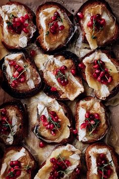 baked potatoes with cranberry sauce and goat cheese on parchment paper, ready to be eaten