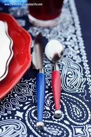 red, white and blue utensils are sitting on a table