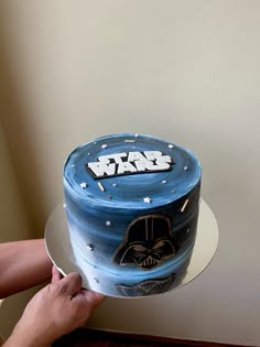 a star wars themed cake is being held by someone