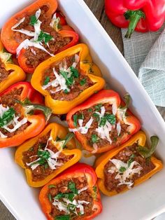 several stuffed peppers in a white casserole dish