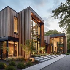 the exterior of a modern house with wood sidings and glass windows on each side