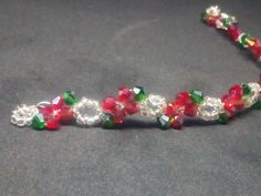 The Poinsettia-handmade jewelry,beaded bracelet,crystal bracelet,fantasy bracelet,Valentine gift,Valentine jewelry,gifts for women The Poinsettia is also known as the Alexandrian plant in Greece and also referred to as the Plant of Bliss. It's a plant that every home welcomes during the Christmas holiday season, as it's considered good luck to have one! So why not carry that good luck and beauty on your wrist and not just throughout the holidays, but every day of the year? Crafted with Swarovksi 4mm bicone crystals in the traditional red and green colors of the poinsettia plant, interspersed with silver-or gold-seed beads, this is THE statement piece of jewelry  you want for the holidays-and beyond!;) Please feel free to contact me for any questions! Fantasy Armband, Fantasy Bracelet, Cristal Bracelet, Poinsettia Plant, Valentine Gifts Jewelry, Valentine Jewelry, Bracelet Crystal, Gift Valentine, Jewelry Beaded