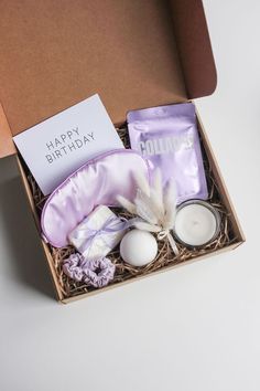 an open birthday box with candles, soaps and other items