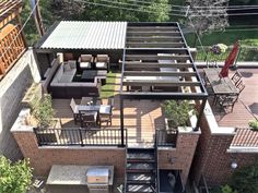 an aerial view of a house with stairs leading up to the roof and patio area