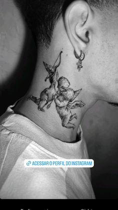 the back of a man's neck with an angel and cupid tattoo on it