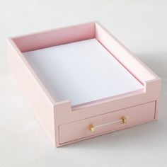 a pink box with two drawers on the bottom and one drawer open to reveal a sheet of paper