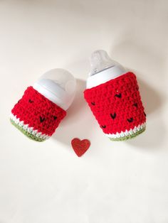 two watermelon sippy cups sitting next to each other on top of a white surface