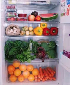 an open refrigerator filled with lots of fresh fruits and vegetables