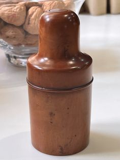 a chocolate covered jar sitting on top of a table next to a bowl of cookies