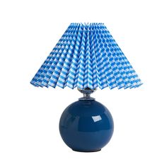 a blue table lamp with a checkered shade on the top and bottom, against a white background