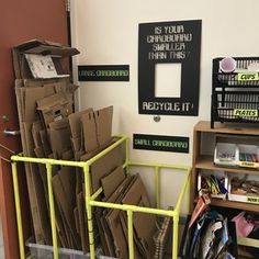 a room filled with lots of boxes and papers on top of a yellow carton