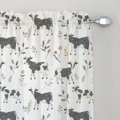 a curtain with cows and flowers on it