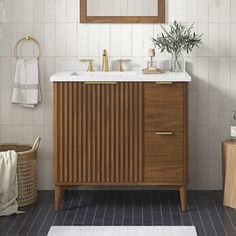 a bathroom with a sink, mirror and towel rack