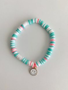 a bracelet with a smiley face charm on it