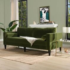 a living room with a green couch and two lamps