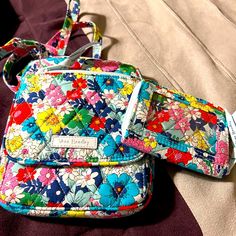 Vera Bradley Crossbody With Wallet In Great Condition. This Is A Great Crossbody In A Flora Color With No Tears Or Stains. Crossbody Was Only Used Once And Wallet Was Never Used. Purple Travel Pouch Wallet, Purple Travel Bag With Card Slots, Multicolor Shoulder Bag With Card Slots For Travel, Purple Travel Wallet Pouch, Purple Pouch Wallet For Travel, Casual Multicolor Wallet With Cell Phone Pocket, Multicolor Everyday Wallet With Mobile Phone Bag, Everyday Multicolor Bags With Card Slots, Multicolor On-the-go Wallets