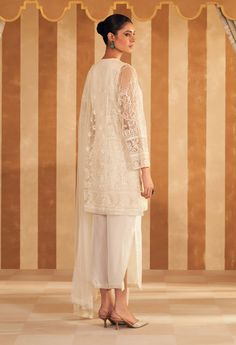 Step into refined elegance with the ivory new embroidered kurta, perfectly paired with luxurious silk pants and a delicate net embroidered dupatta. The kurta features intricate embroidery in soft ivory, adding a touch of sophistication. The silk pants offer a sleek, complementary finish, while the net dupatta, adorned with delicate embroidery, completes the ensemble with an ethereal charm. Ideal for both festive and formal occasions, this outfit effortlessly blends classic grace with contemporar Ridhi Mehra, Embroidered Crop Tops, Delicate Embroidery, Embroidered Dupatta, Net Dupatta, Intricate Embroidery, Silk Pants, Kurta Set, The Net