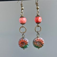 "Coral and Green Earrings - Coral and Green Czech Glass Wheel Beads dangle from Twisted Antiqued Copper Rings and Sponge Coral Beads Antiqued Brass Earwires Earrings measure just over 2.25\" from top of earwires to bottom of beads." Victorian Style Jewelry, Sponge Coral, Dragonfly Jewelry, Real Flower Jewelry, Dragonfly Earrings, Green Earrings, Christmas Jewelry, Beaded Dangles, Nature Jewelry