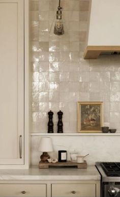 a kitchen with white cabinets and an oven