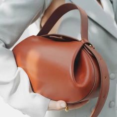 Syndi Oval Mini Doctors Bag - 3 Colors. Classic faux leather top handle bag eith adjustible strap. Carry as top handle or clutch style. Comes with shoulder strap. Dimension : L28 cm x W10 cm x H16 cm Gender: WomenItem Type: BagMain Material: PUShape: HobosLining Material: PolyesterPattern Type: SolidInterior: Cell Phone PocketHardness: SOFTClosure Type: Hasp Red Tote, Popular Bags, Round Bag, Leather Handbags Tote, Casual Bags, Fashion Handbags, Satchel Bags, Shoulder Bag Women, Crossbody Shoulder Bag