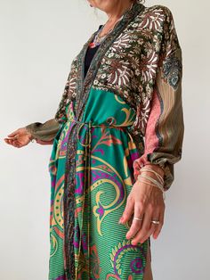 "This is silk puff sleeve kimono with the most gorgeous flow,  it's puffed sleeve that adds style, the belt is removable, and this item is so versatile.  can be paired up with jeans and t.shirt for a more casual look,  or dress it up with some smart trousers, wear it on the beach, spa or to a dinner party the choice is really yours MEASURE ONE SIZE Medium  Recommended for UK size 8-12 Length approx. 45\" MATERIAL *up cycled vintage silk  * no lining  More boho style ideas at  https://www.etsy.co Silk V-neck Kimono For Daywear, Chic Flowy Long Sleeve Kimono, Chic Long Sleeve Flowy Kimono, Elegant Long Sleeve Robe For Vacation, Silk Wrap Kimono For Daywear, Chic Kimono With Tie Waist And Kimono Sleeves, Summer Long Sleeve Robe With Tie Waist, Long Sleeve Beach Robe With Tie Waist, Silk Tie Waist Kimono For Loungewear