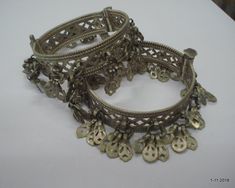 Vintage Antique ethnic collectible very nice tribal old silver charm Bracelet or bangle pair from Rajasthan India. Worn by Banjara tribal people of Rajasthan. Beautiful workmanship all over the piece, adorn with silver charms. One quarter-hinged part can be open by central pin. Original old pair in good condition with great antique look. great pair for gothic & tribal style belly dance. Inner diameter across - 5 cm(1.96")Inner circumference -15.7 cm (6.18")width include charms - 2.7 cm(1")we Vintage Antique Silver Bangle For Ceremonial Occasions, Antique Bangle For Festival, Traditional Antique Silver Bangle For Festivals, Traditional Heavy Antique Silver Bangle, Antique Silver Jewelry Indian, Antique Silver Festival Bangle, Kuchi Jewelry, Belly Dance Jewelry, Foot Bracelet