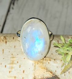 "Natural Premium Grade Oval Moonstone .925 Sterling Silver Ring Size 7.5 weighs 6.7 Grams measures 15/16\" x 5/8\" GS19. Much more blue flash than picture shows! This is a handpicked natural stone, the exact one shown in picture.  The sterling silver is .925 and stamped.  Each piece is hand made by artisans in my shop.  The quality of the stones and the silver workmanship is impressive.  Please look at other items in my store.  I sell ready made jewelry with hand crafted silver work, pendants with a sterling silver bails and beautiful unique cabochons for jewelry wire wrapping and weaving. You will pay exact amount on shipping plus $1 for supplies and labor. All items are shipped within a couple of days after payment and are shipped USPS first class or international first class.  Items are Spiritual Moonstone Ring With Large Stone In Sterling Silver, Spiritual Sterling Silver Moonstone Ring With Large Stone, Spiritual Large Stone Moonstone Ring In Sterling Silver, Spiritual Oval Moonstone Ring With Natural Stones, Spiritual Large Stone Sterling Silver Moonstone Ring, Celestial Oval Moonstone Ring In Sterling Silver, White Mystical Moonstone Ring In Sterling Silver, White Moonstone Ring In Sterling Silver For Healing, Mystical White Moonstone Ring In Moon Shape