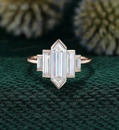 an emerald cut diamond engagement ring with three baguets