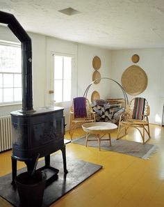 a living room filled with furniture and a wood stove