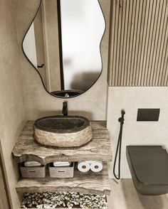 a bathroom with a sink, mirror and other items on the counter top in front of it