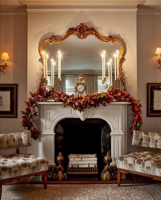 a living room filled with furniture and a fire place under a mirror on the wall