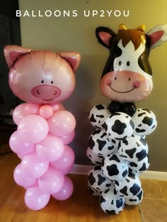 two inflatable balloons shaped like animals are standing next to each other on the floor