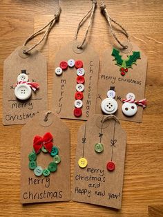 four christmas gift tags with buttons attached to them