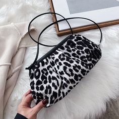 The Clutch Bag is the new Must Have all the It Girls are wearing! Crafted from a mix of leopard printed fabric and super soft vegan leather, this clutch features a frame enveloped in folds to create a voluminous shape, constructed with side tassels that can extend into a full shoulder strap. Carry yours in-hand as a clutch or use the strap when you need to stay hands-free. Brown Black Leopard & White Black Leopard colors available Polyester Vegan Leather Imported Big: Length: 27cm, Height: 15cm, Chic Clutch For Daily Use In Fall, Chic Leopard Print Shoulder Bag, Chic Fall Clutch For Daily Use, Trendy Leopard Print Clutch Bag, Chic Leopard Print Clutch Bag, Chic Leopard Print Party Bag, Chic Leopard Print Party Bags, The It Girls, Leopard Bag