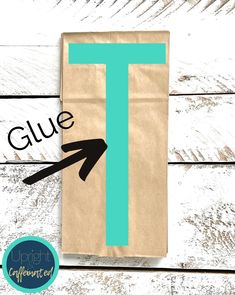 a paper bag with the letter t on it and an arrow pointing to the left