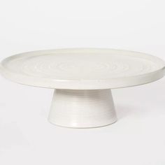 a white cake plate sitting on top of a table