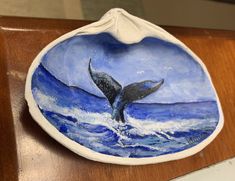 a ceramic plate with a whale tail on it