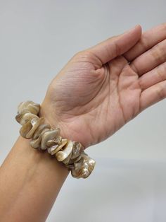 "Natural Sea Shell Bracelet. Puka Shell Bracelet - Stretch bracelet. This Seashell Bracelet is stretch. Beach Bracelet, Surfer Style. Hawaiian Design. This Shell Bracelet is perfect for Womens or Teens Handmade with 3/4\" Inch\" Hand-Selected High Quality Clam Shells. Fits Most Size. Stretch from 5\" Inches up to 6\" Inches. Around the wrist. FAST & FREE SHIPPING! Visit my Etsy Shop to see more Designs! Handmade Puka Necklaces, Bracelets and Earrings: https://www.etsy.com/shop/FreedomLifeSty Elegant Beige Beach Bracelet, Elegant Adjustable Shell Bracelet, Brown Bangle Bracelet For Beach, Brown Bangle Bracelet For The Beach, Shell Oyster Bracelet As Gift, Elegant Shell Bracelet As A Gift, Adjustable Beige Shell Jewelry, Beige Shell Jewelry For Gifts, Elegant Adjustable Stretch Bracelet For Beach