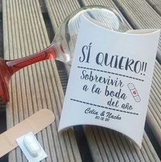 a bottle of wine sitting on top of a wooden table next to a paper towel