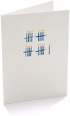 a white card with blue and yellow dots on it, in the shape of numbers