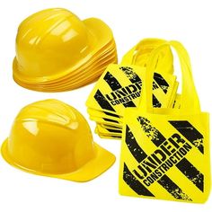 yellow construction hats and safety vests are stacked on top of each other