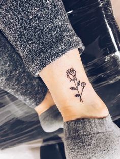 a small rose tattoo on the ankle