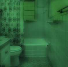 a blurry image of a bathroom with a toilet, sink and bathtub in it