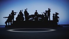 the silhouettes of musicians are shown against a blue background