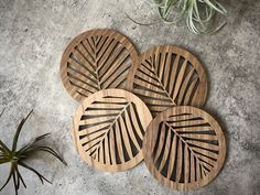 three wooden coasters sitting on top of a cement floor