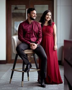 a man and woman are sitting on a stool