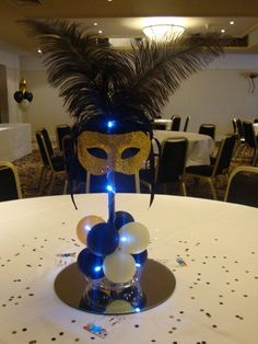 a mask on top of a table in a room with white tables and black chairs