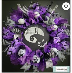 a halloween wreath with purple and black decorations