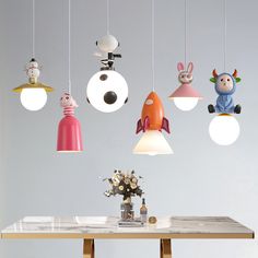 a table with some lights hanging from it's sides and an animal figure on top